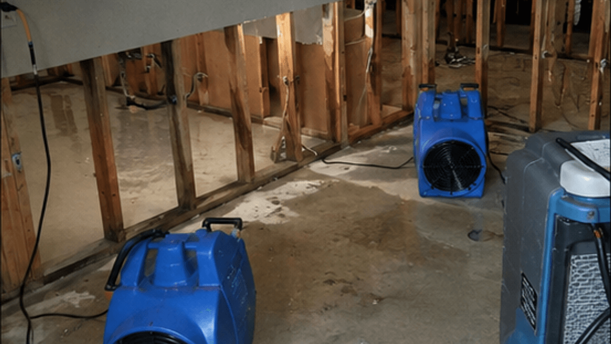 Air movers and drying equipment running in a partially opened water-damaged room